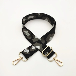 Close-up of leopard print bag strap with silver glitter and gold metal lobster clasps