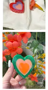 Detail of colorful layered heart-shaped hair claw clips in red and green vibrant colors