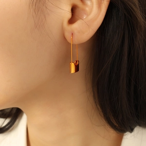 Minimalist golden safety pin style earrings for women with chic streetwear aesthetic