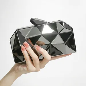 Fashionable black geometric clutch bag with mirror finish and metallic chain for evening events