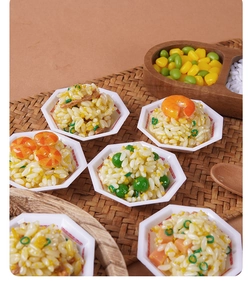 Close-up of realistic miniature rice bowls with shrimp and peas on a woven mat background