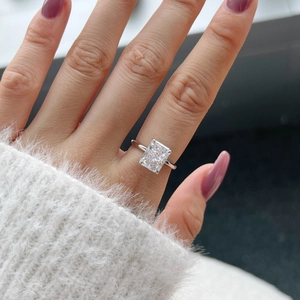 Macro shot of a rectangular cut sparkling zircon ring with a classic four-claw setting