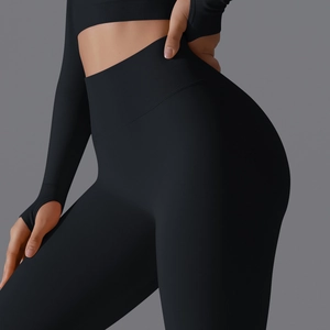 Detail of high-waisted seamless black yoga leggings with tummy control ribbed waistband