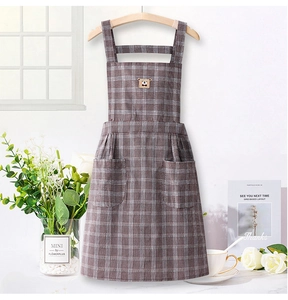 Close-up of brown checkered cotton apron with bear embroidery and large pockets
