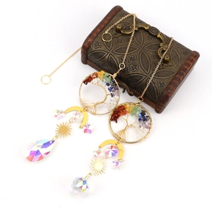 Detail of Tree of Life suncatcher with colorful chips and crystal prisms on white background