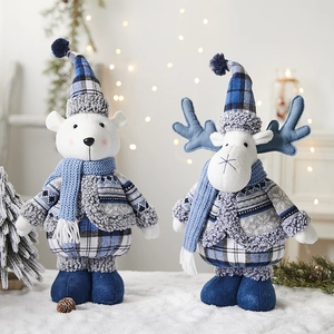 Blue Christmas plush polar bear and reindeer dolls in winter festive holiday display