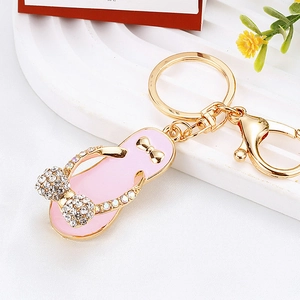 Detailed view of pink rhinestone flip-flop keychain with gold bow and lobster clasp