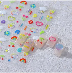 Detailed 3D puffy nail art stickers with rainbow and cherry patterns on tips
