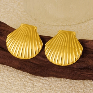 Macro shot of 18k gold plated stainless steel seashell studs with textured metallic finish