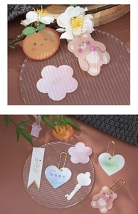 Flat lay of colorful cartoon gift tags including bear and orange shapes with greetings