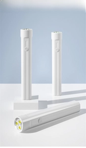 Detailed view of portable mini LED nail lamp with three bulbs and power button in white