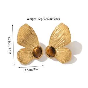Detailed close-up of vintage butterfly earrings with tiger eye stone and 18k gold plating