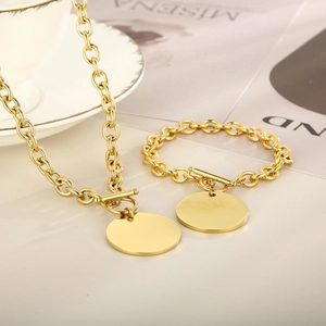 Detailed view of golden titanium steel cable chain set with OT clasp and round tag