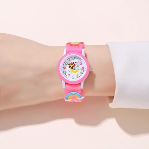 Close-up of kids pink quartz watch with cartoon sun, moon and rainbow silicone strap