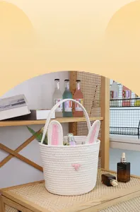 Close-up of woven cotton rope storage basket featuring cute pink bunny ears and face