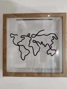 Macro shot of square wooden shadow box featuring map print and top coin slot design
