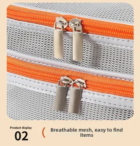 Detail of breathable gray mesh fabric with dual orange zippers for travel storage bag