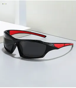 Detail of sports sunglasses featuring black frames and red honeycomb anti-slip rubber grips