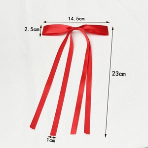 Red polyester ribbon hair clip with double streamers and dimensions 14.5x23cm