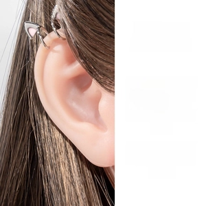 Detail of silver cat ear cuff with pink accents displayed on an ear model