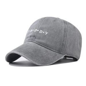 Detailed view of gray washed cotton baseball cap with DADDY embroidery and heart symbols