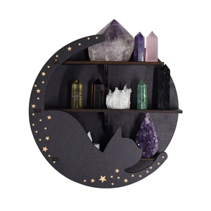 Detail of black moon and cat wooden shelf with gold stars for crystal display