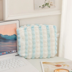 Close-up of blue and white striped puffy cloud makeup bag with soft bubble texture