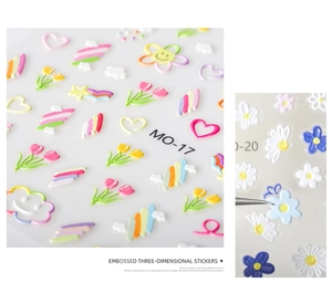 Detailed macro view of 5D embossed floral nail stickers with 3D texture and colorful hearts