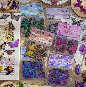 Macro detail of waterproof butterfly stickers in vintage aesthetic packaging for scrapbooking