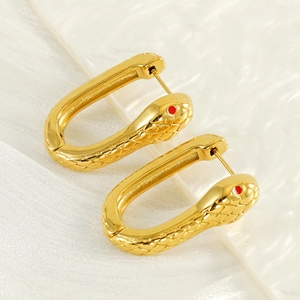 Golden snake hoop earrings with red eyes and scale texture for a unique aesthetic look