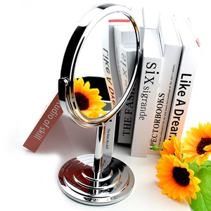 Modern double-sided round chrome vanity mirror with a magnifying side and sunflower decor