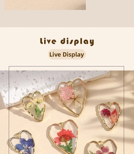 Detail of heart-shaped resin earrings featuring real dried flowers and gold alloy frame