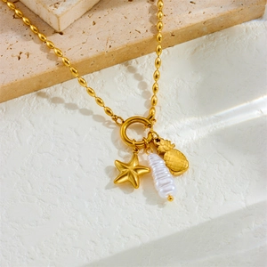 Gold beaded chain necklace featuring a starfish, pineapple, and baroque pearl pendant