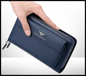 Detail shot of the textured navy leather and gold logo on a double zipper men's clutch