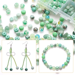 Macro detail of green and white cracked glass beads set for DIY jewelry making kits