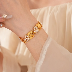 Detail of vintage gold leaf bracelet with pearls and crystals on a model wrist