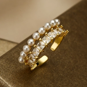Gold double-layered open ring featuring white pearls and square cubic zirconia stones