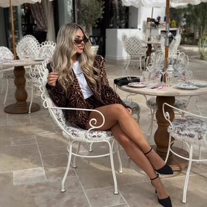 Women's leopard print blazer and shorts set with a white tee for a stylish street look