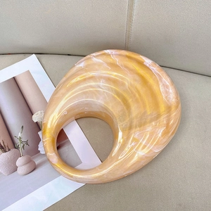 Detail showing the amber yellow marbled acrylic handle with a smooth resin finish