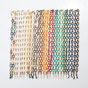 Flat lay of colorful acrylic and metal eyeglass chains in various vibrant patterns