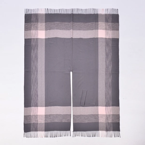 Detail of grey and pink plaid shawl featuring a front slit design and fringe tassel hemline