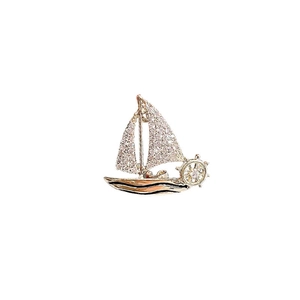 Exquisite gold sailing ship brooch with sparkling rhinestones and nautical rudder detail