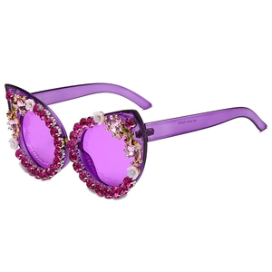 Purple heart sunglasses with pink rhinestones and white flowers at 45-degree angle
