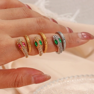 Detailed view of adjustable snake rings in gold and silver with sparkling crystal eyes
