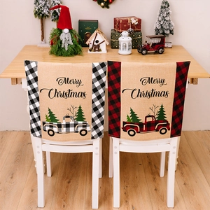 Detail of Christmas chair covers with vintage truck patterns and festive plaid borders