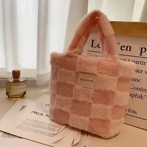 Pink waffle fleece bucket bag with plush checkerboard pattern and woven patch detail