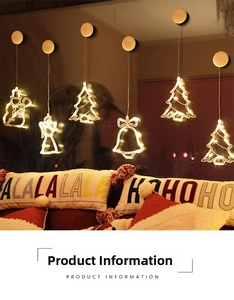 Close-up of LED Christmas window suction lights with warm yellow tree and angel designs