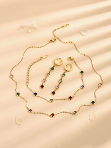 Luxury jewelry set with colorful zirconia necklace, bracelet and earrings on gold metal