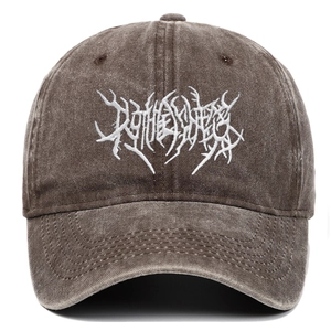 Detailed macro view of gothic white embroidery on vintage washed dark cotton baseball cap