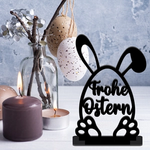 Macro shot of black laser-cut wooden Easter bunny ornament with Frohe Ostern engraving